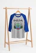 A 3/4 sleeve raglan t-shirt on a black mannequin torso, featuring a heather gray body and royal blue sleeves. The front is printed with the text 'Ponte Vicks AND KEEP GOING' above a cartoon jar graphic.