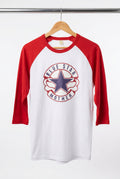 A red and white raglan baseball t-shirt hanging on a wooden hanger on a black wire display rack. The shirt features a circular 'Blue Star Mother' graphic on the chest with a blue star and red and white text.